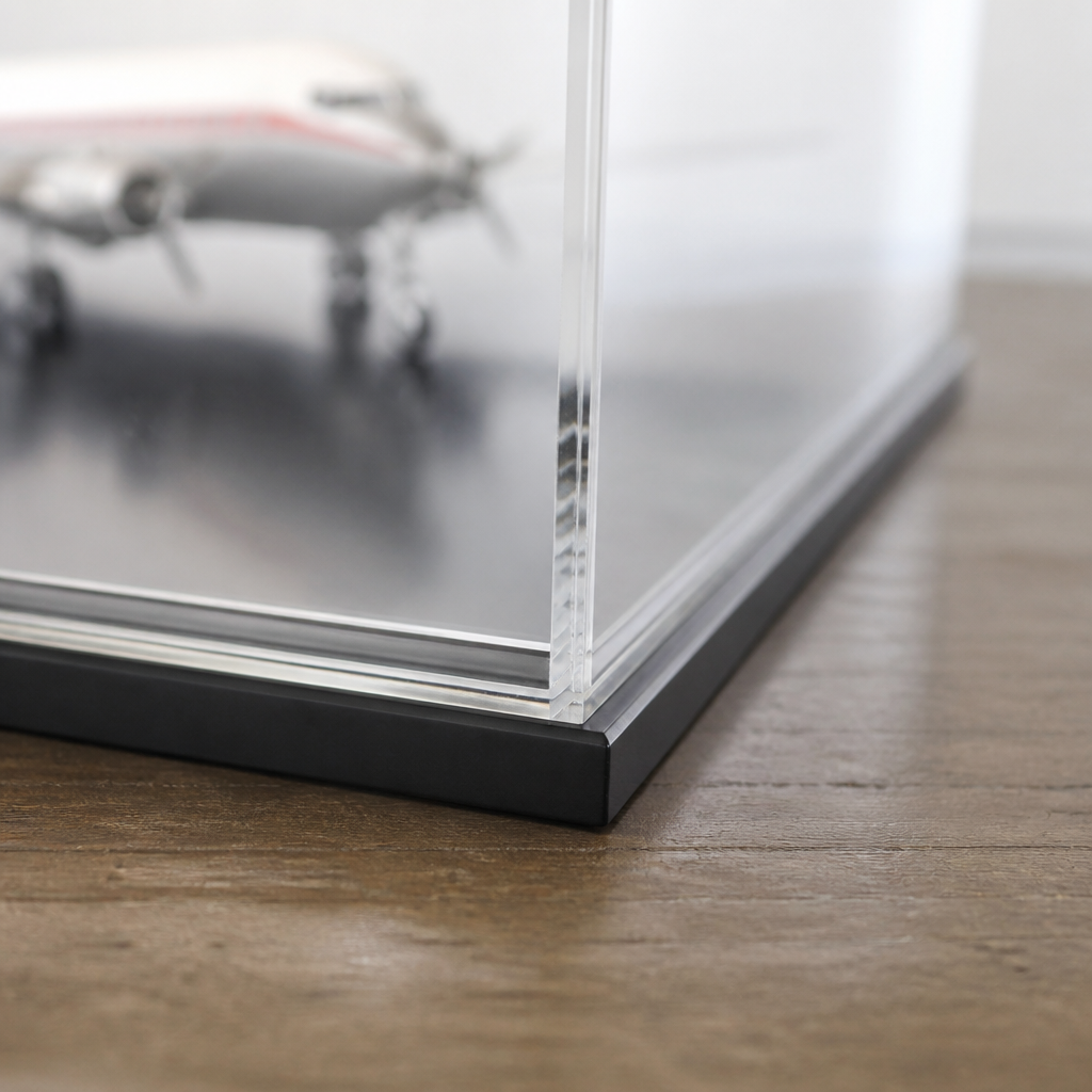 Close view of the joint between a display case lid and its base, showing the rebate that keeps dust out