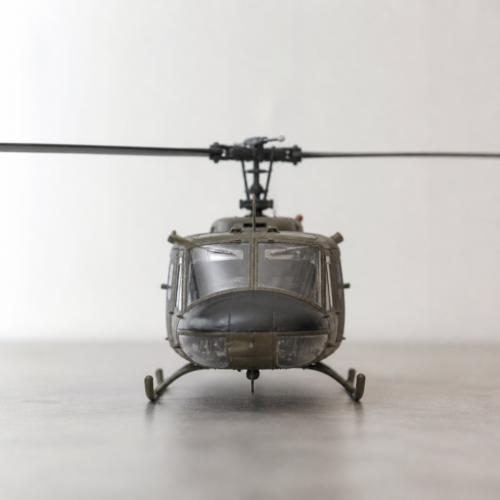 A helicopter model photographed from the front, rotor blades level, against a plain background